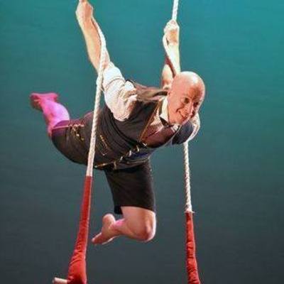 Performer from SHOW Circus Studio in Easthampton, Massachusetts, hanging by arms above a trapeze