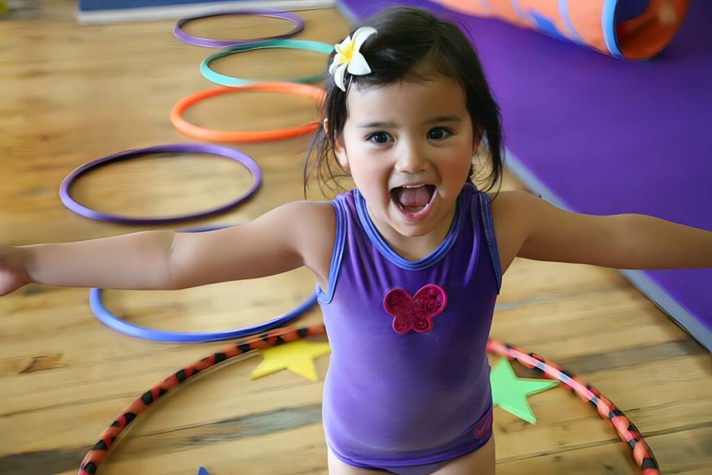 Excited kid in a purple leotard at SHOW Circus Studio in Easthampton, Massachusetts