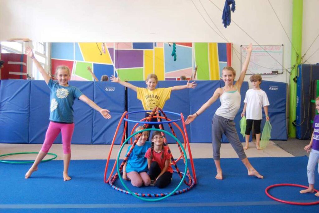 Six kids having a "ta-da" moment at SHOW Circus Studio in Easthampton, Massachusetts