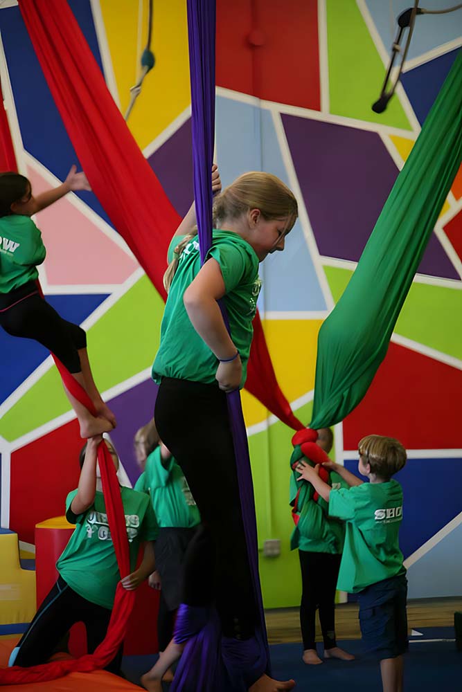 Kids at camp at SHOW Circus Studio in Easthampton, Massachusetts, trying fabric equipment